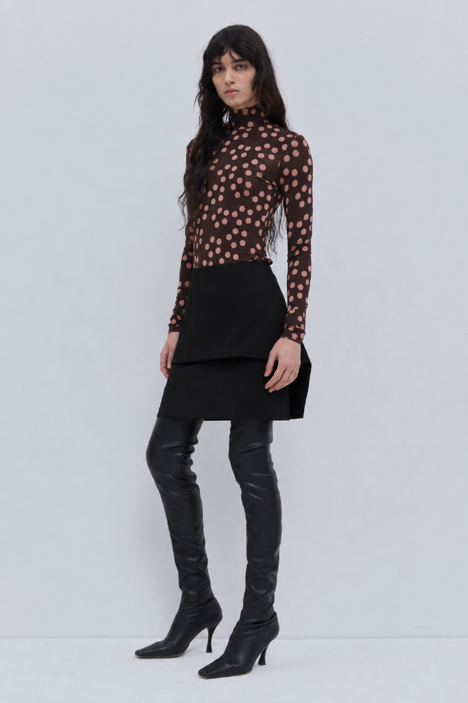 Side view of black double-layer woven mini skirt.