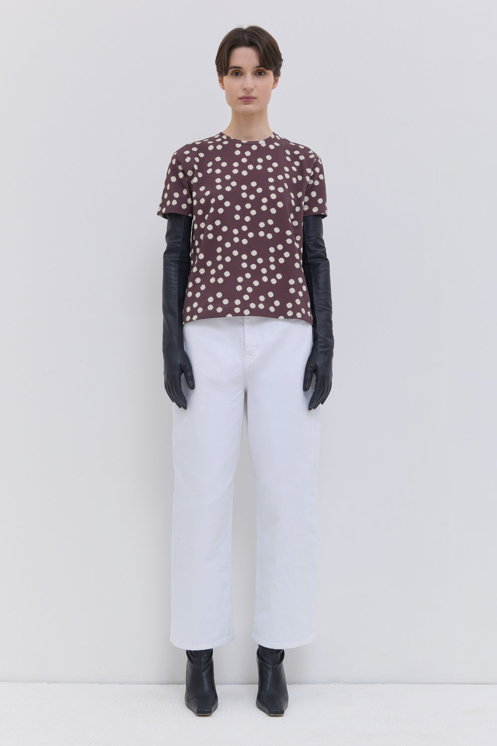 Back view of optical white cropped denim pants with patch pockets.