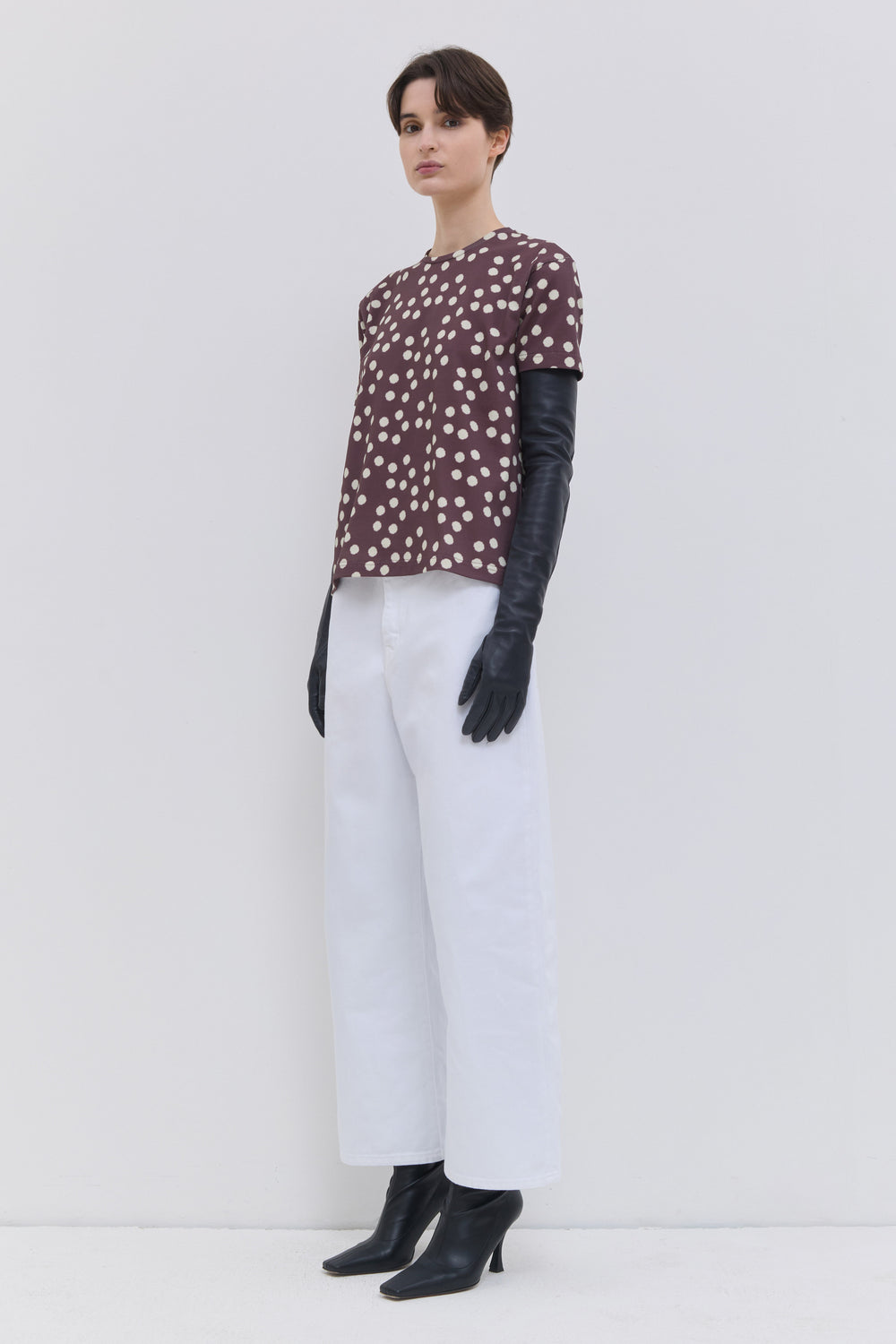 Optical white cropped wide-leg jeans styled with a lightweight knit.