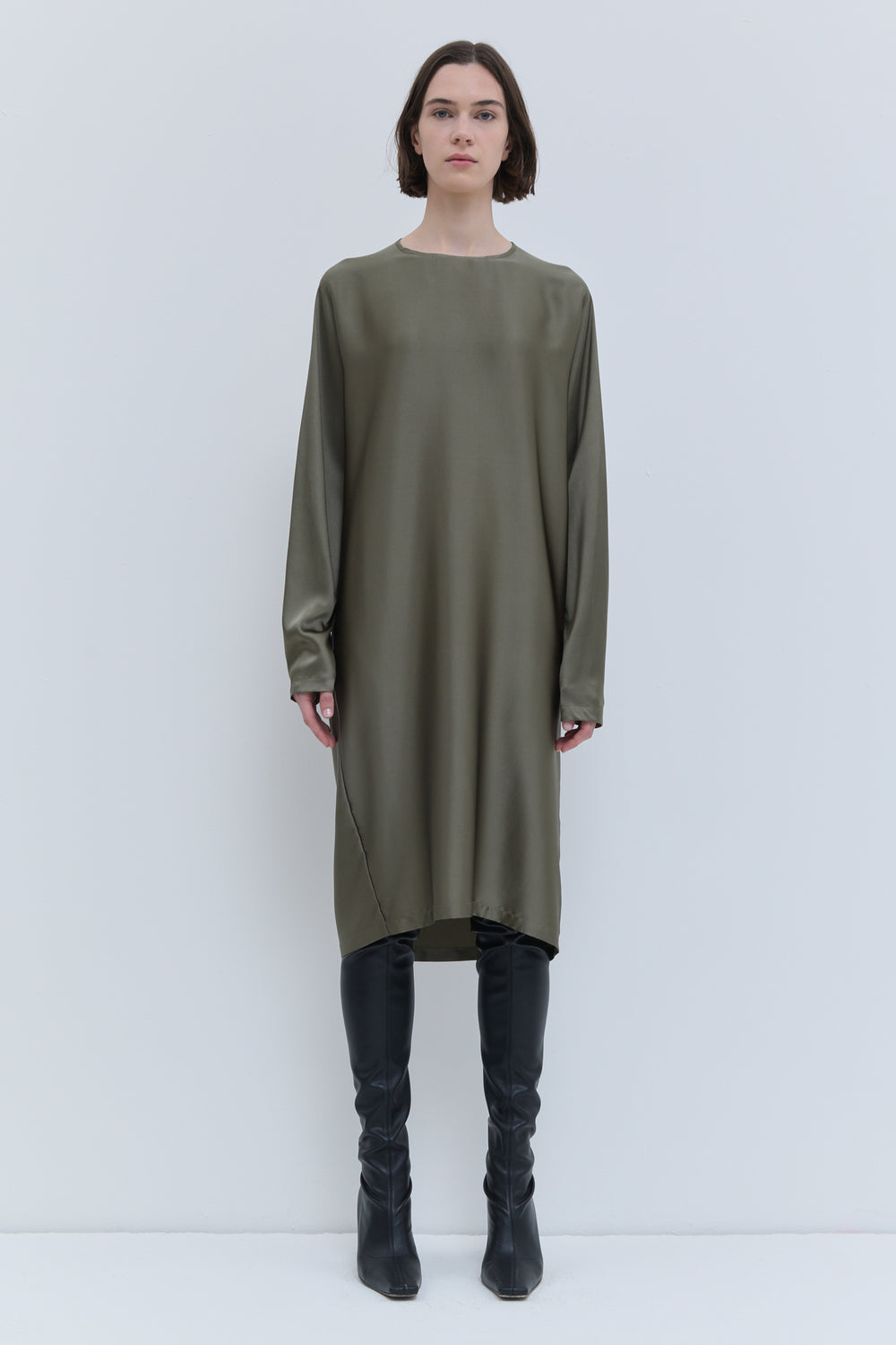 Side view of the artichoke Deira dress with detachable triangle scarf detail.