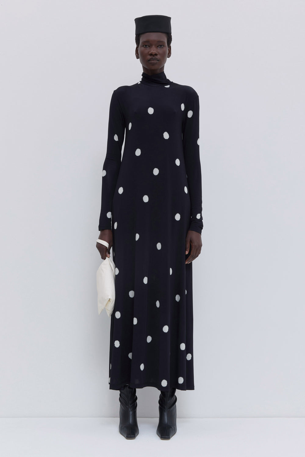 Christian Wijnants Dewika maxi jersey dress in black with oversized white polka dot print, featuring a turtleneck, long sleeves and flowing silhouette.