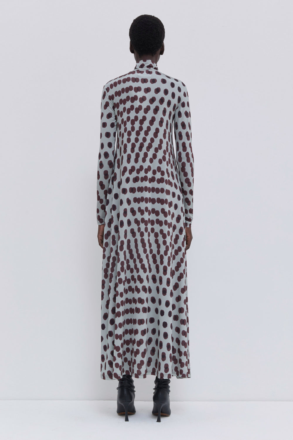 Back view of the Dewika jersey maxi dress in plum Polika print with a flowing fit and turtleneck design.
