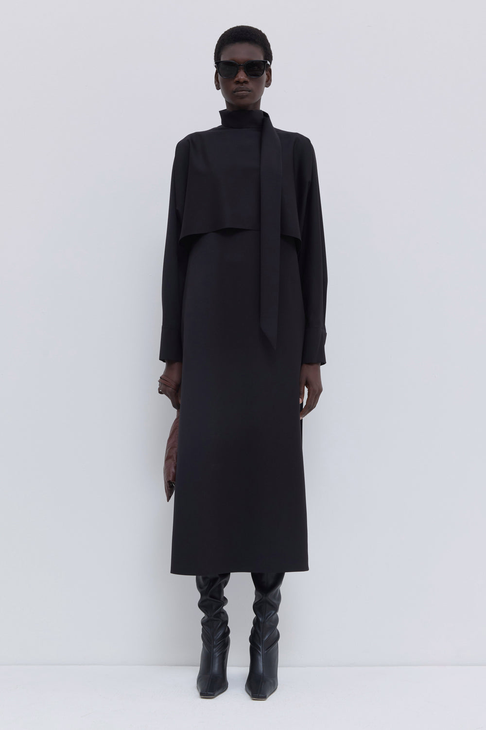 Black virgin wool batwing sleeve dress with soft scarf collar and layered front panel.