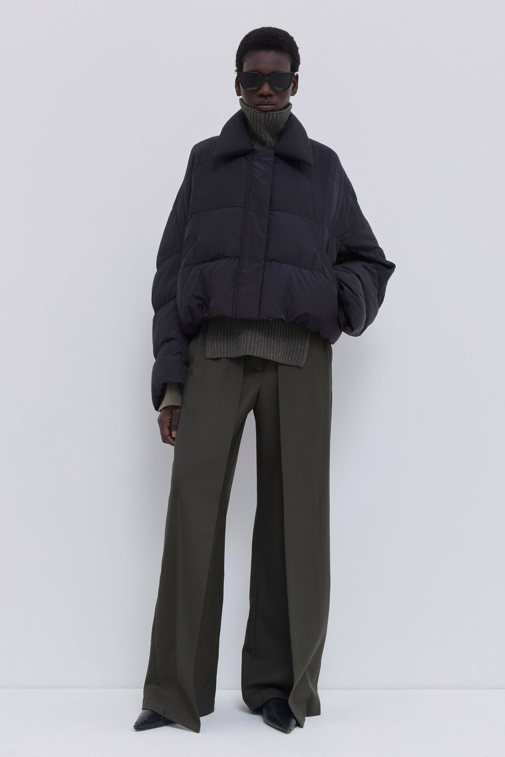 Side view of the Jani black cropped puffer jacket.