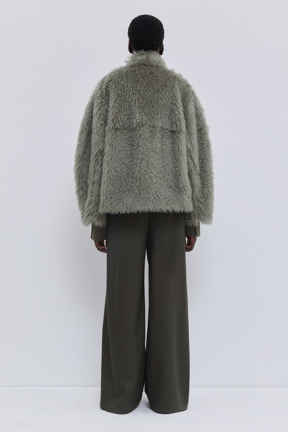 Back view of a sage faux fur jacket in premium Steiff mohair fabric.