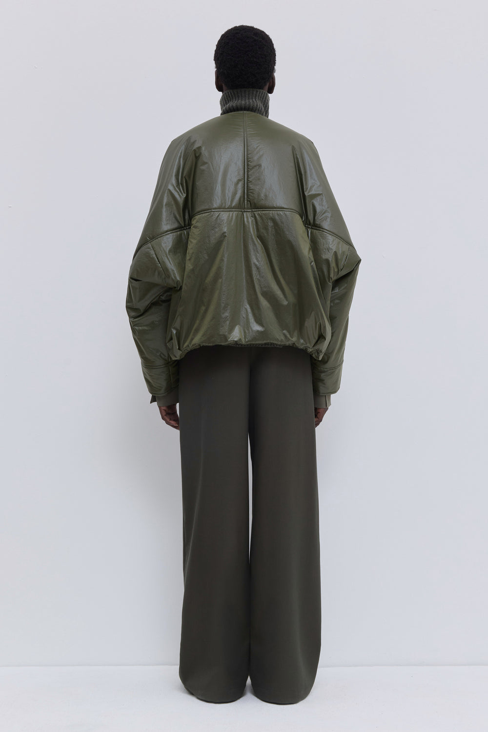 Olive Jelana V-neck padded jacket with subtle sheen, front zipper and adjustable hem detail back view