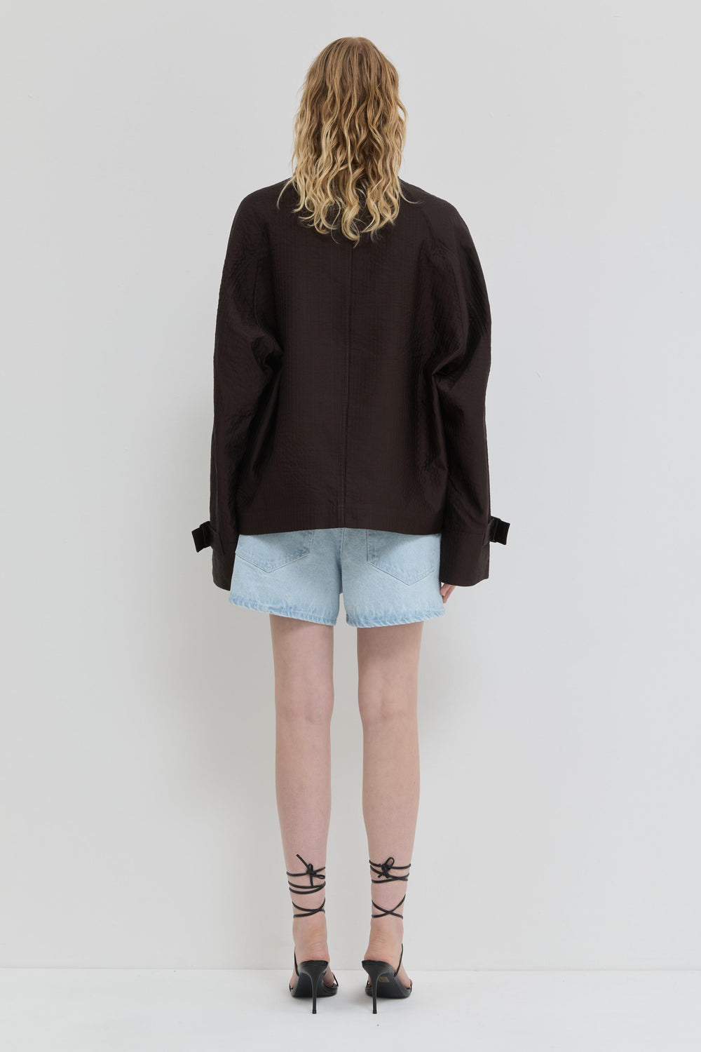 Chocolate quilted jacket with belted cuffs and relaxed fit