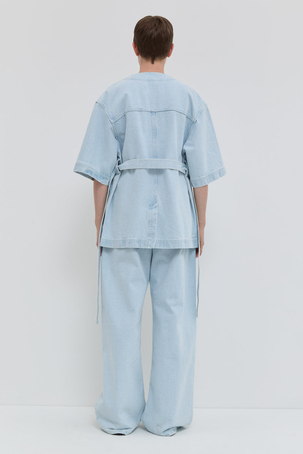 Light blue denim jacket with short kimono sleeves and relaxed fit back view