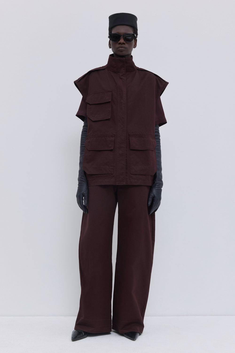Jupi sleeveless jacket styled with matching Piros barrel leg trousers in plum garment-dyed organic cotton.