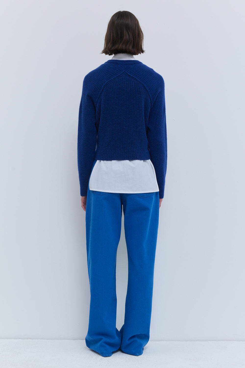 Deep blue knit top with long sleeves and tie front
