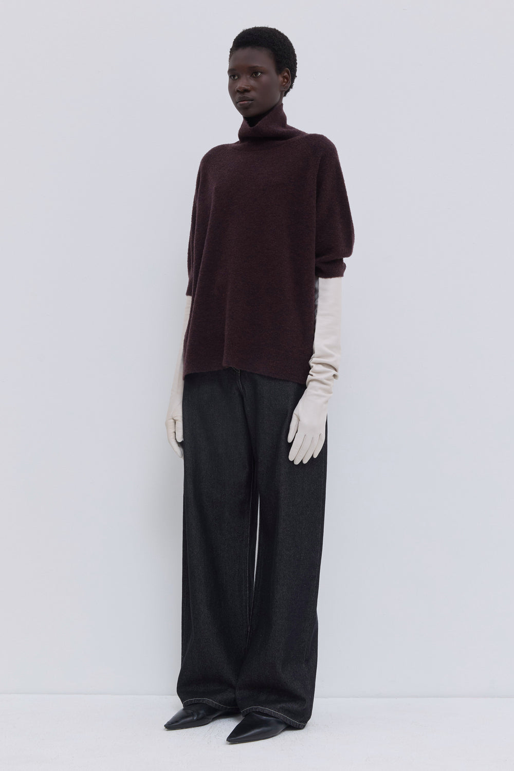 Front view of a luxurious deep plum short-sleeve turtleneck knit in soft bouclé yarn.