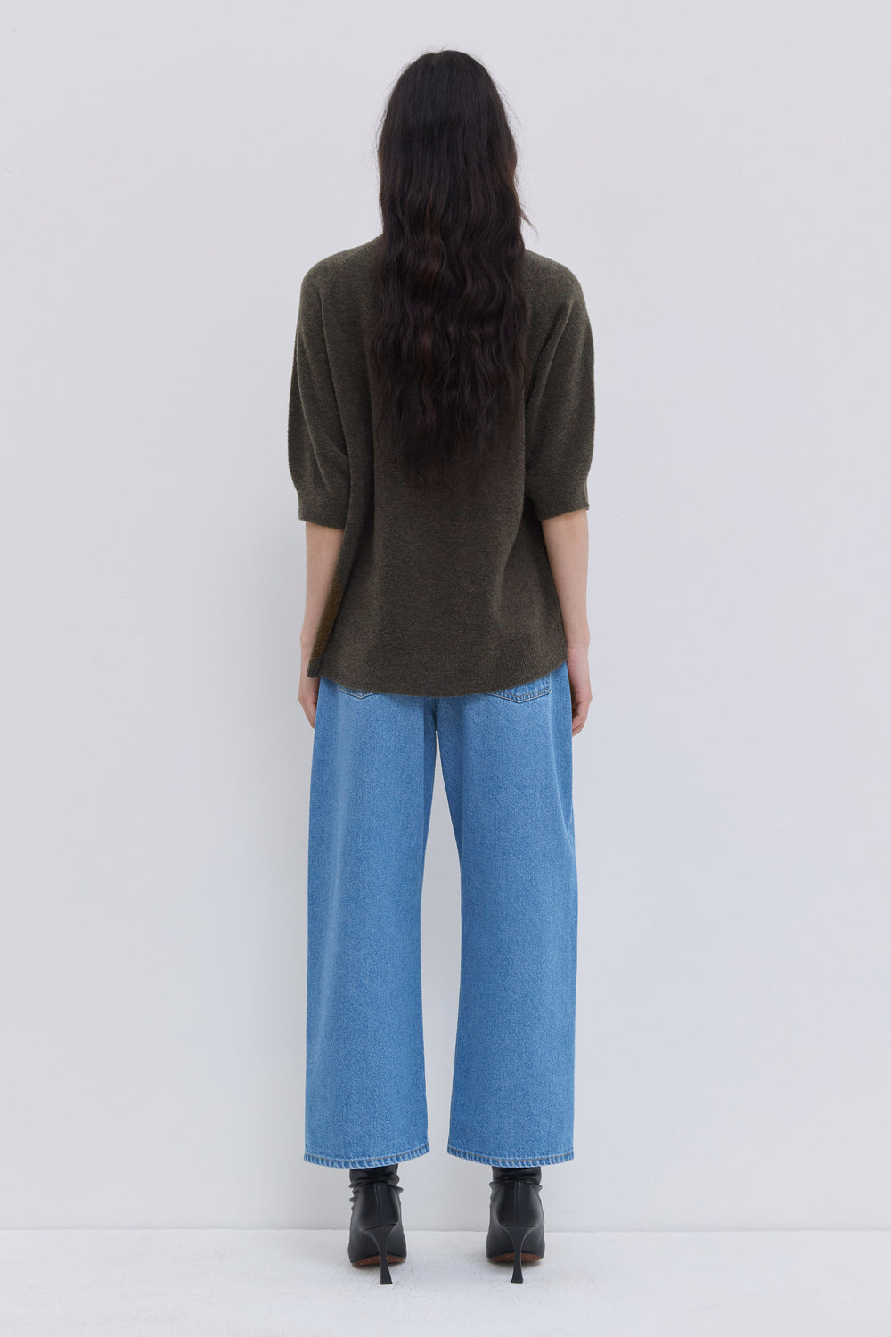Back view of a forest oversized bouclé knit top with short sleeves.