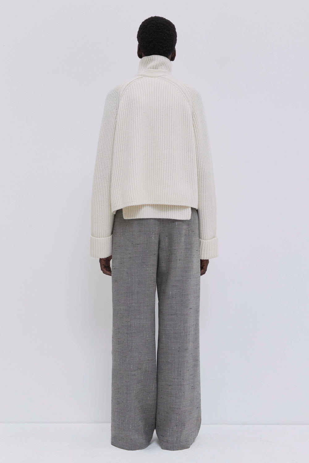 Italian cashmere blend cardigan with patch pockets and ribbed texture.