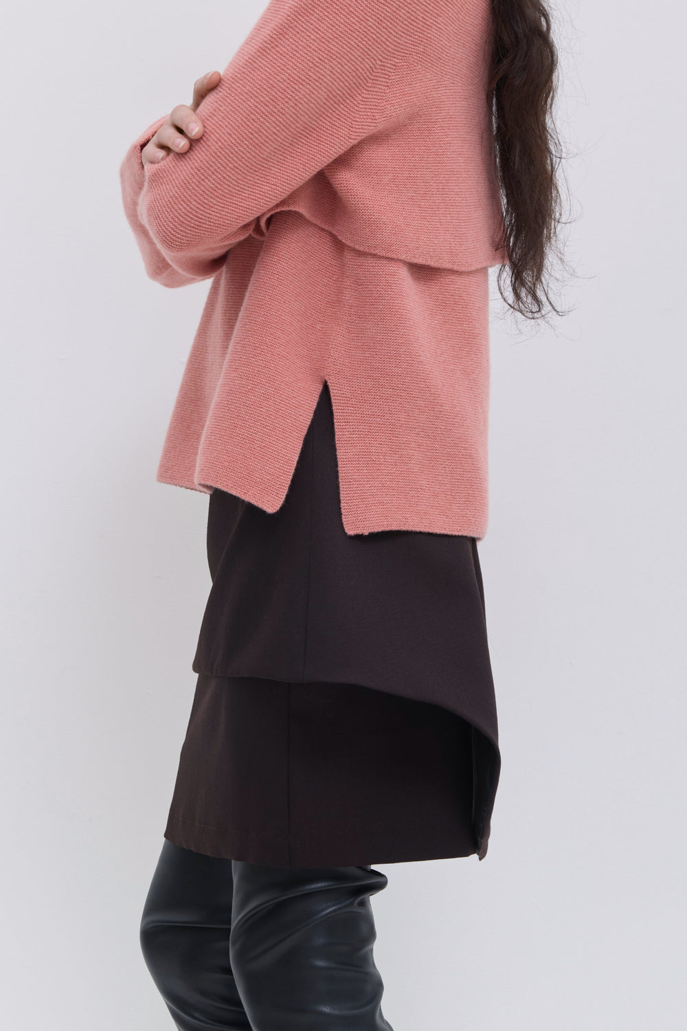 Side view of coral wool sweater with cropped layered design