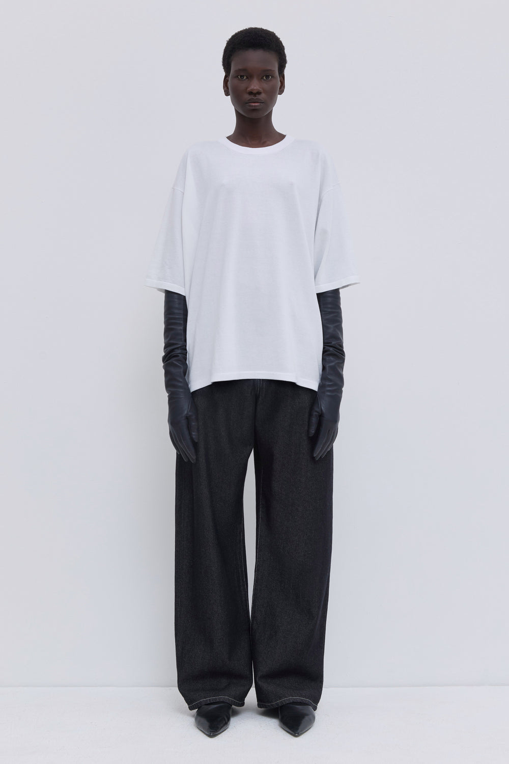 White oversized cotton jersey T-shirt with dropped shoulders and back strap detail.