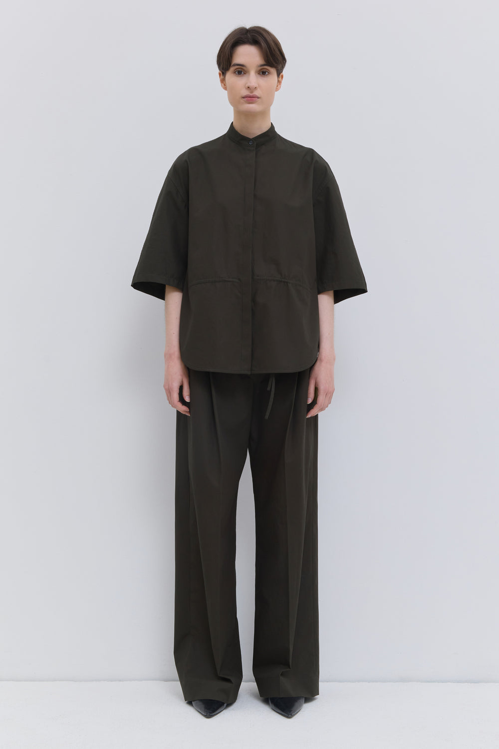 Deep forest cotton wide-leg trousers with front creases.