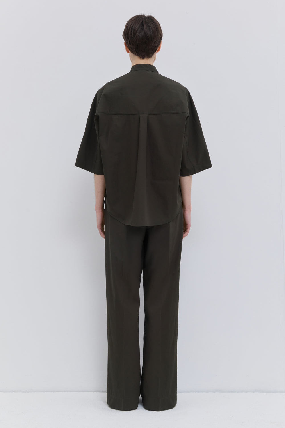 Back view of deep forest wide-leg cotton trousers.