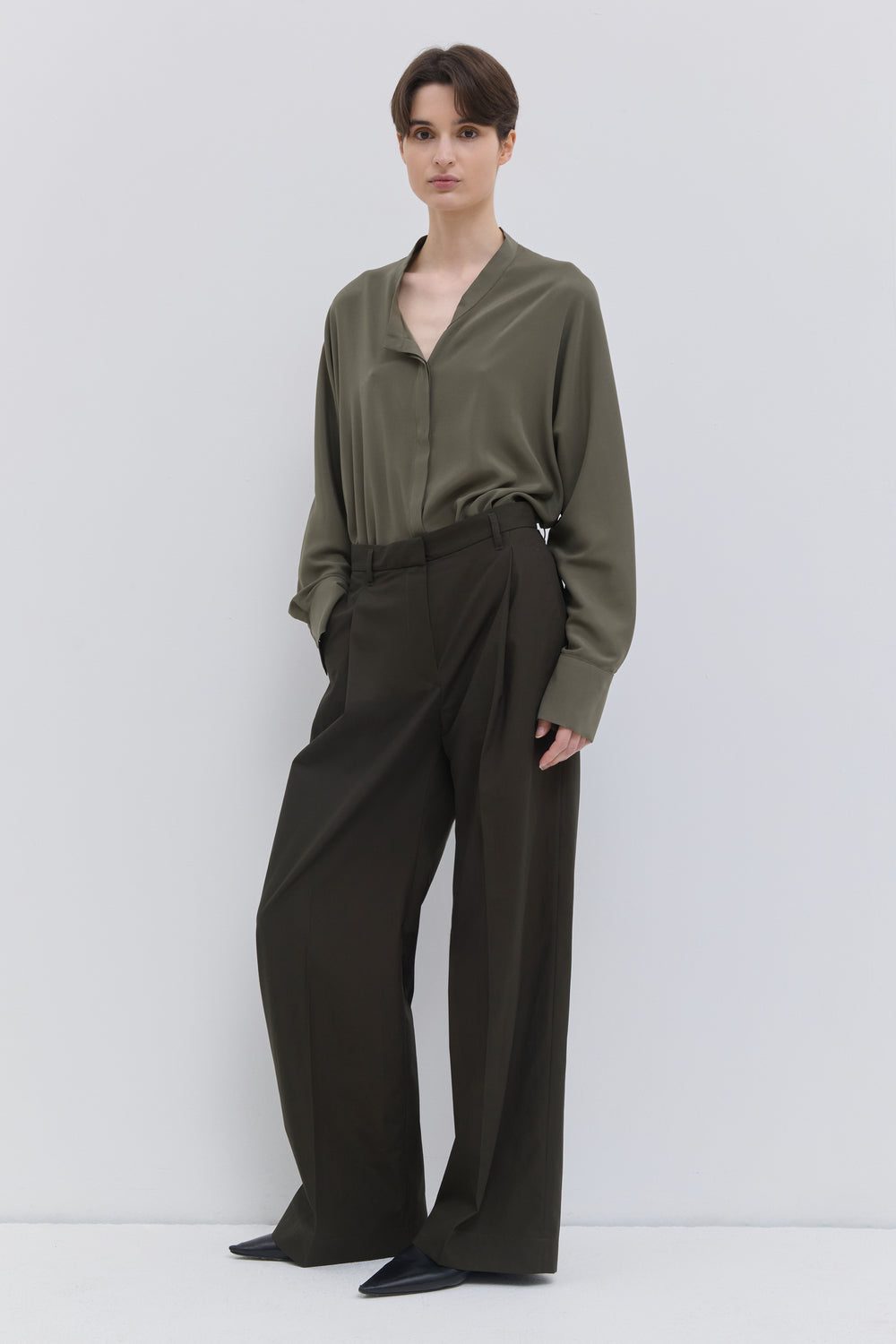 Classic deep forest cotton trousers with pressed front creases.