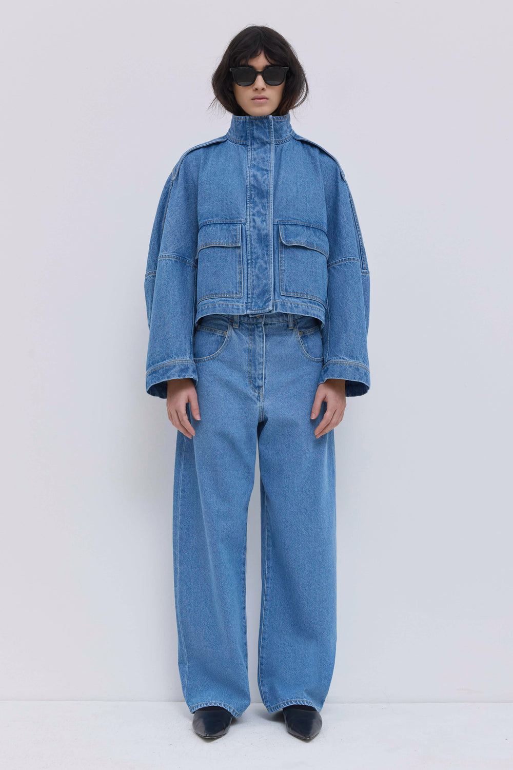 Wide-leg light blue denim jeans with a relaxed fit and classic detailing.