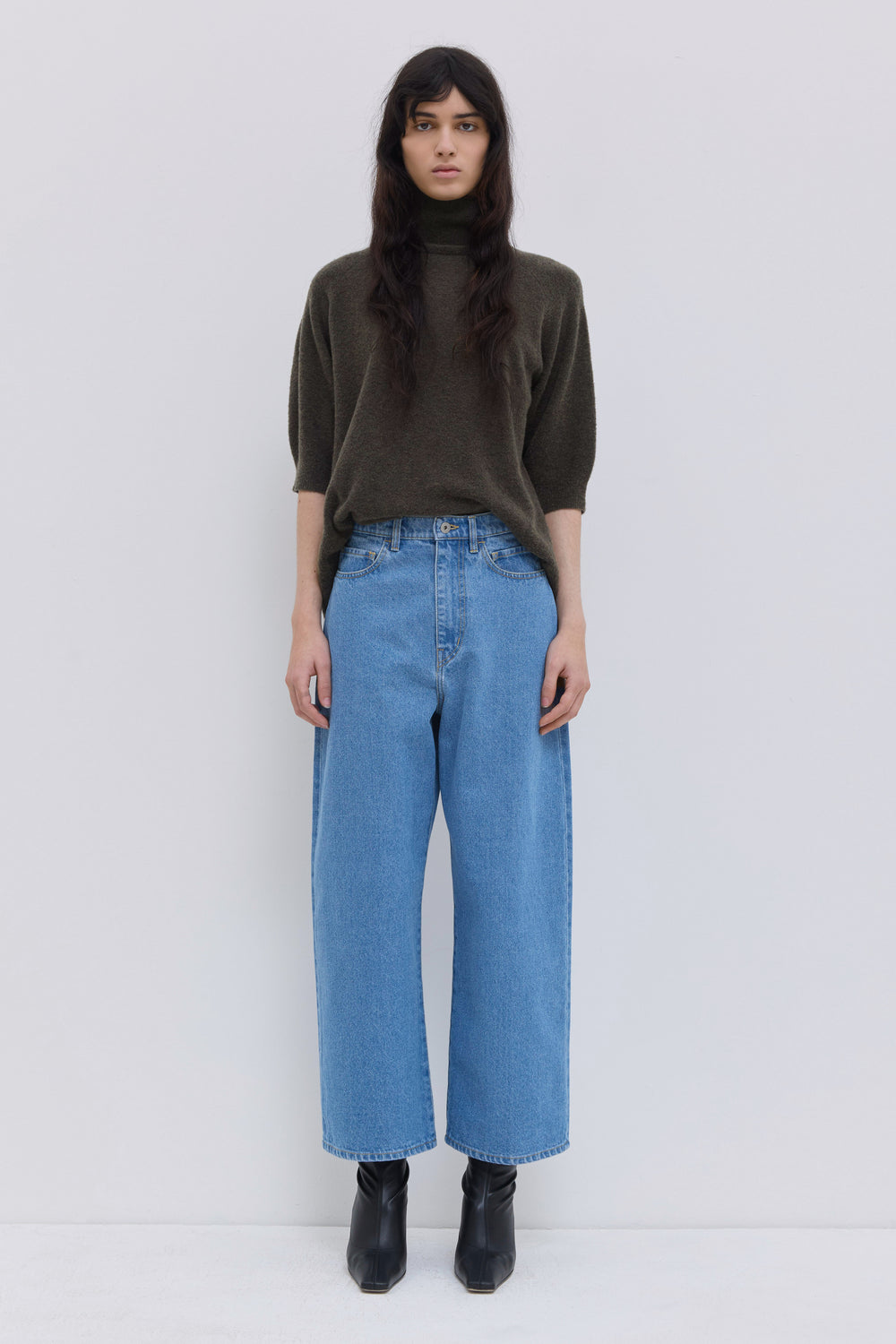 Front view of blue cropped wide-leg denim pants in a washed finish.
