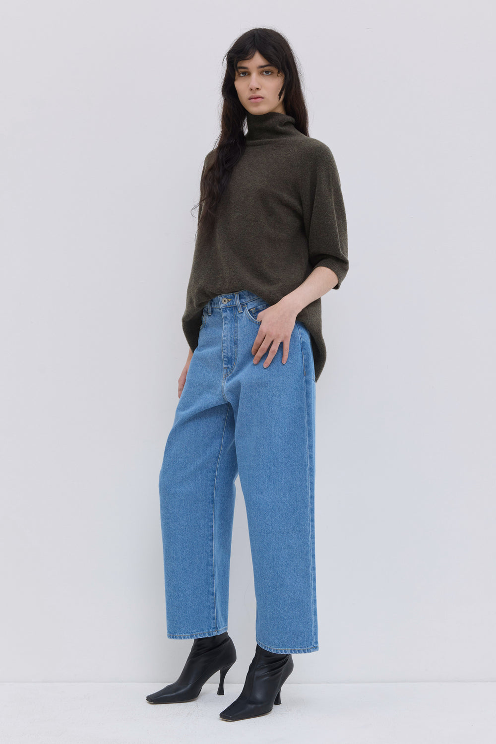 Side view of blue wide-leg cropped denim jeans with a relaxed fit.