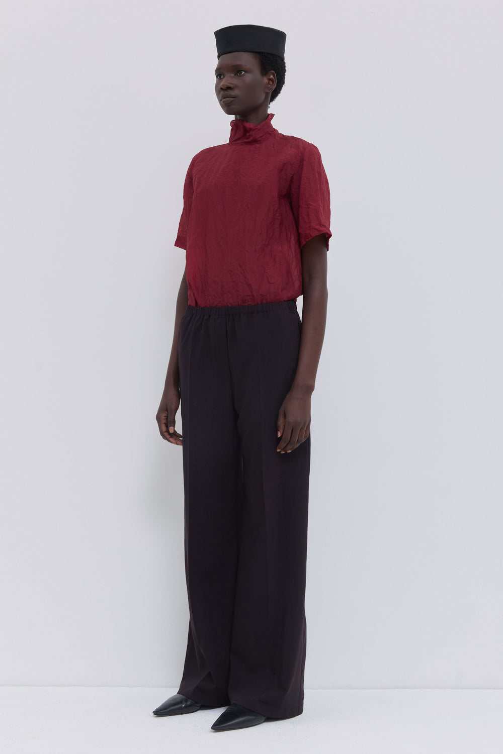 Deep plum wool blend trousers with relaxed fit and rounded pockets