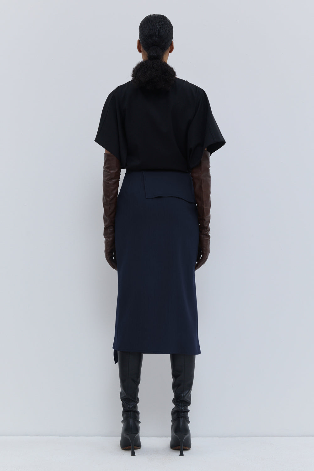 Christian Wijnants Sailo dark navy midi skirt with draped front panel, back view.