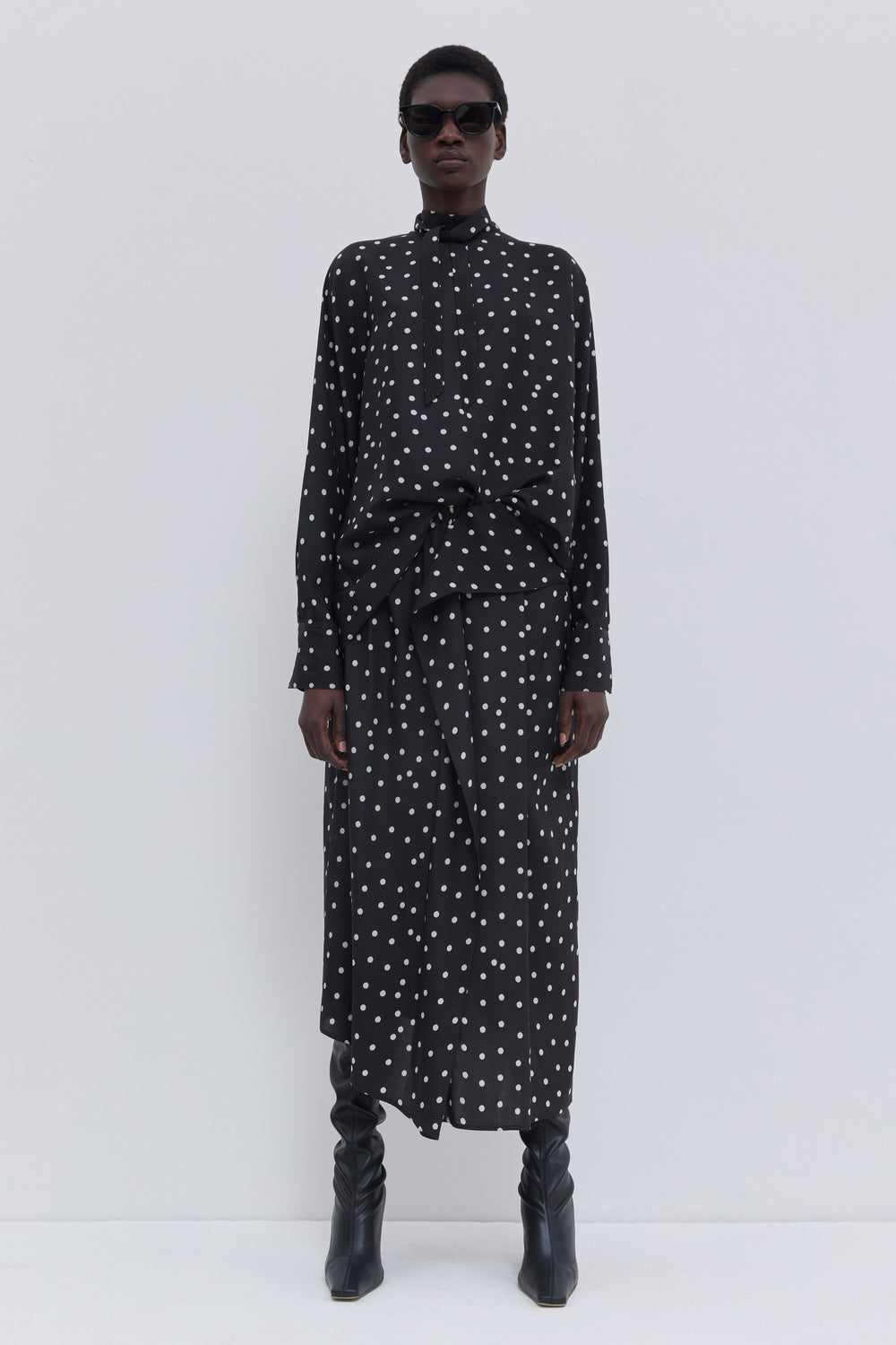 Black dotted draped midi skirt in matte stretch satin paired with a matching printed top by Christian Wijnants.