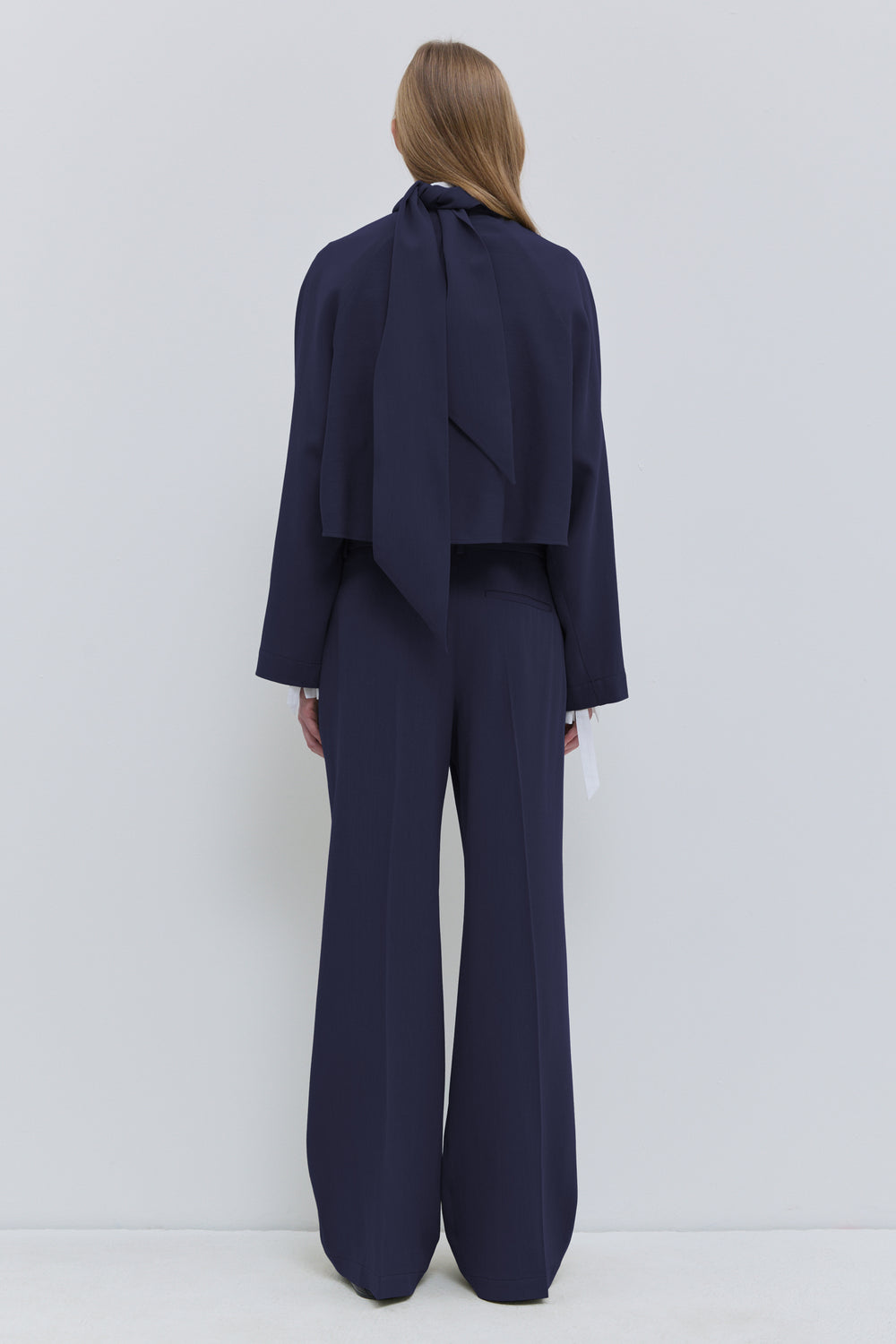 Front view of Christian Wijnants Tesos cropped wool top in dark navy with scarf detail Christian Wijnants